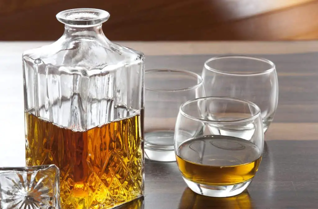 Photo of a crystal decanter set on a table. 