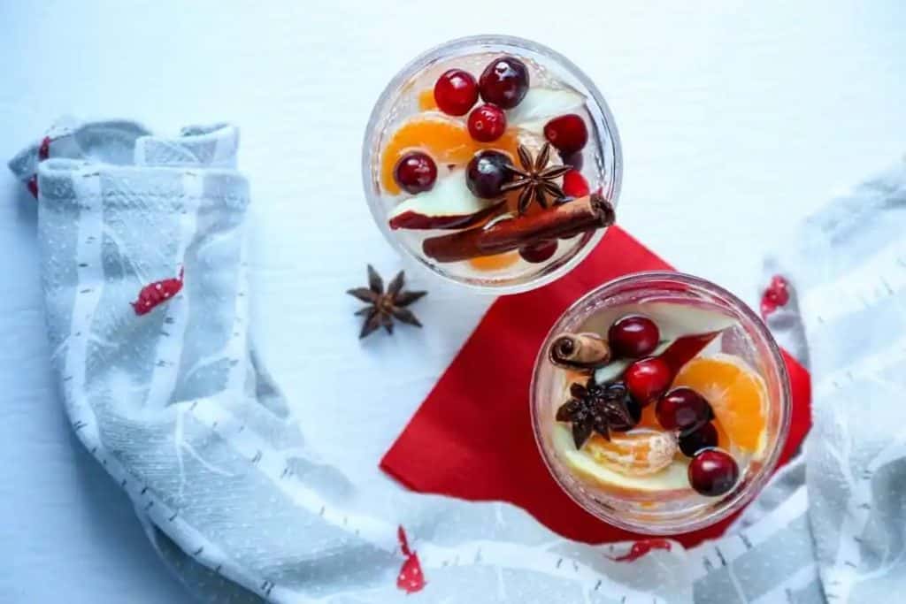 fruit in a white sangria liquid on a white background