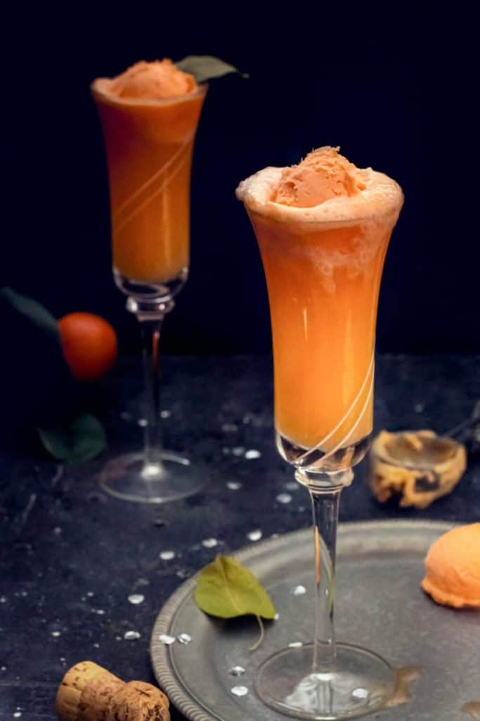 tall glasses with orange sherbet in orange liquid